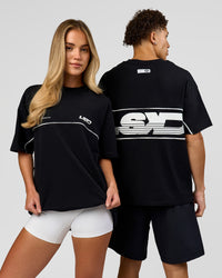 Duo wearing Inline Heavyweight FLXCotton Oversized Tee - Black-White | Model:Issy | Size:XS | Model:Leandro | Size:M | Thumbnail Index: 0