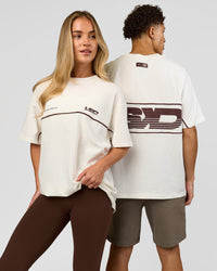 Duo wearing Inline Heavyweight FLXCotton Oversized Tee - Off White-Hot Chocolate | Model:Issy | Size:XS | Model:Leandro | Size:M | Thumbnail Index: 0