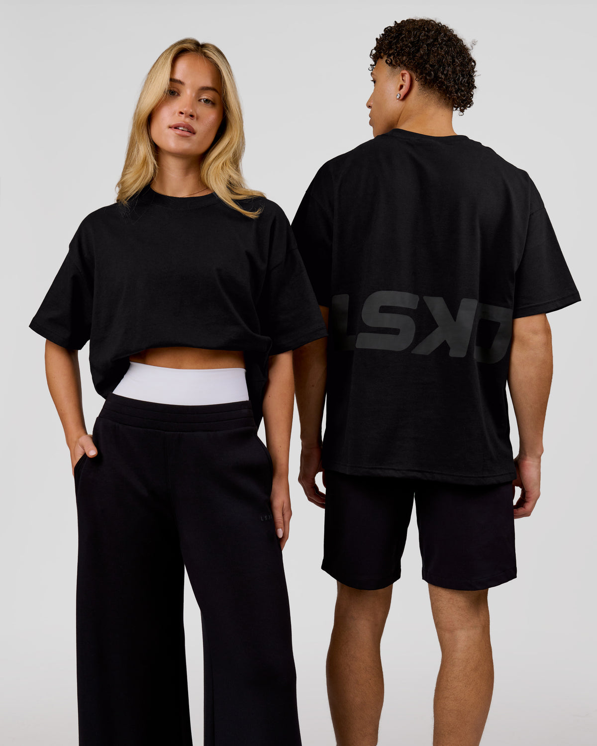 Duo wearing Shadow Mark Heavyweight Oversized Tee - Black-Onyx | Model:Issy | Size:XS | Model:Leandro | Size:M