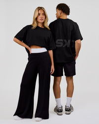 Duo wearing Shadow Mark Heavyweight Oversized Tee - Black-Onyx | Model:Issy | Size:XS | Model:Leandro | Size:M | Thumbnail Index: 9