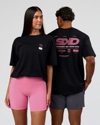Duo wearing Archive FLXCotton Oversized Tee - Black-Candy Pink | Model:Rhiley | Size:XS | Model:Xav | Size:L | Thumbnail Index: 0