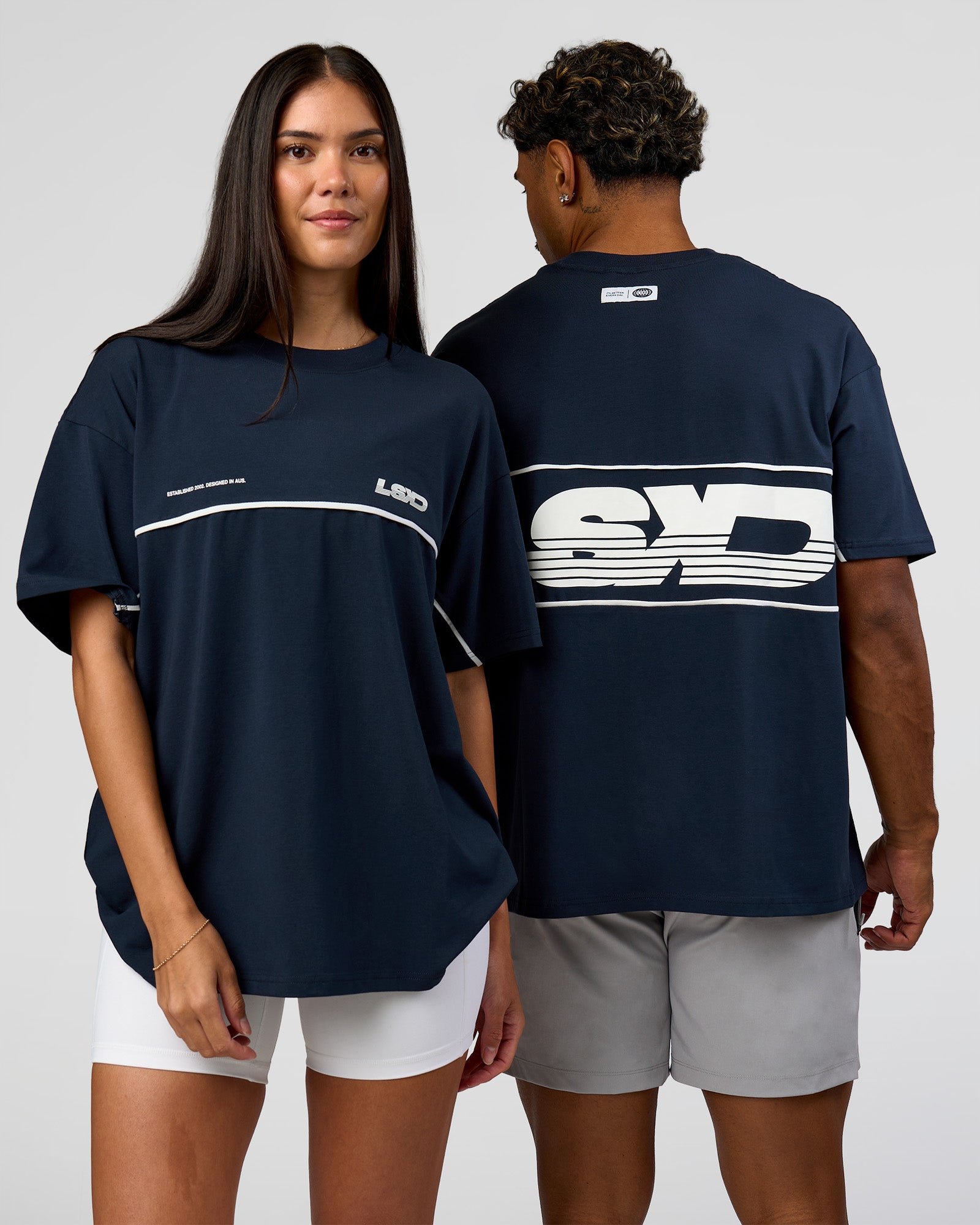 Duo wearing Inline Heavyweight FLXCotton Oversized Tee - Midnight Navy-White | Model:Rhiley | Size:XS | Model:Xav | Size:L