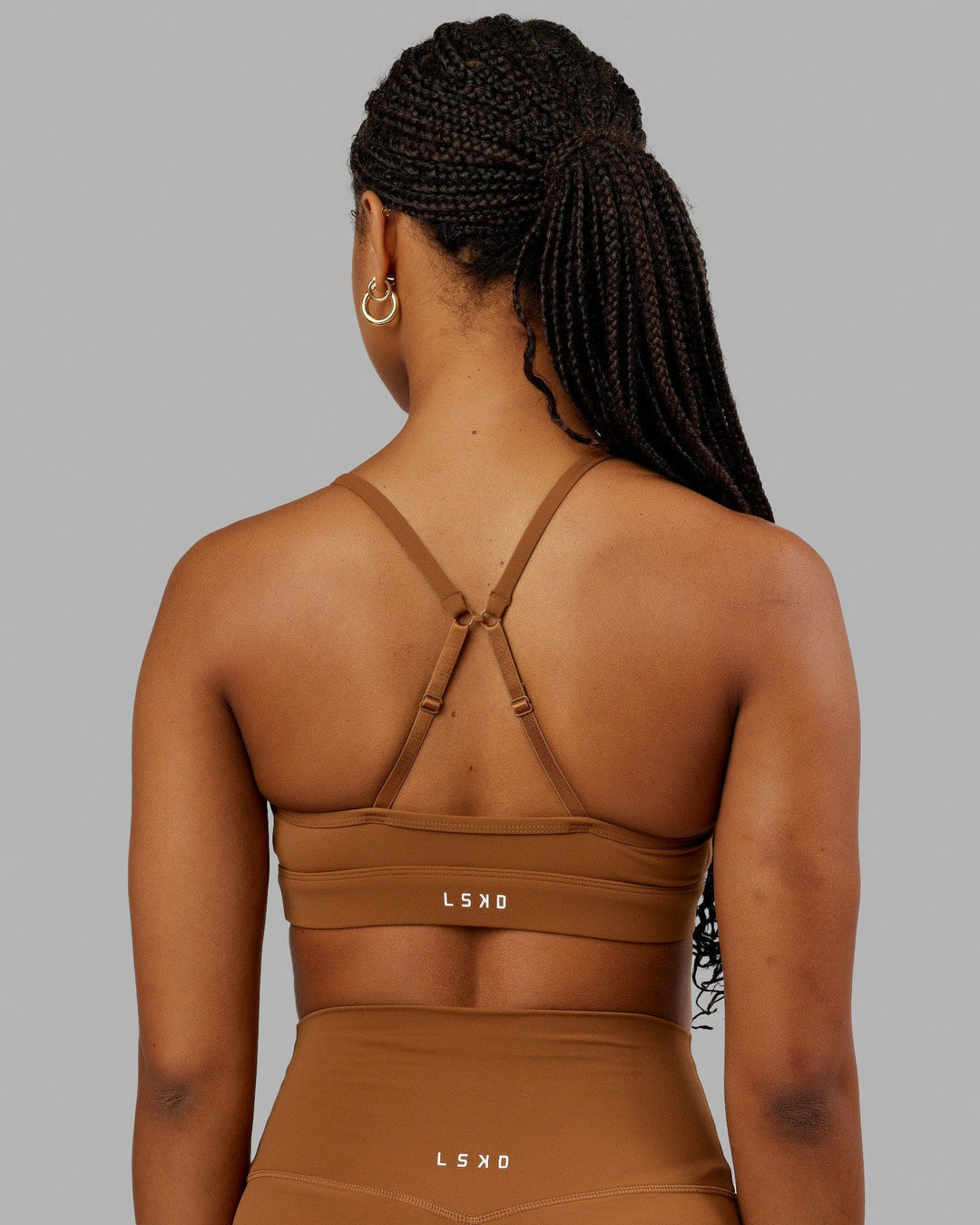 Woman wearing Elixir Sports Bra - Camel