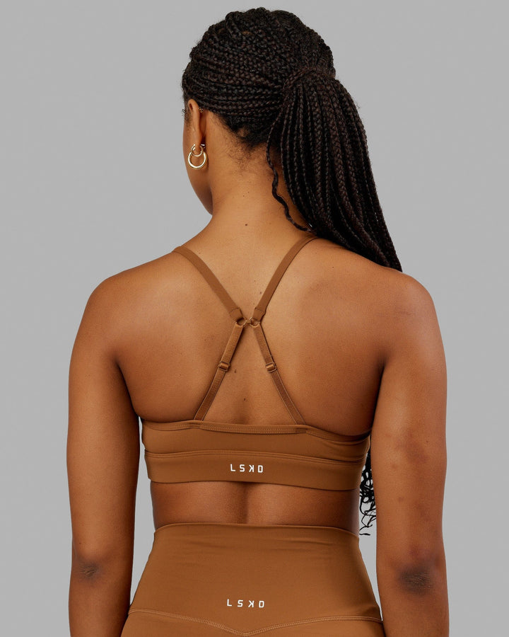 Woman wearing Elixir Sports Bra - Camel