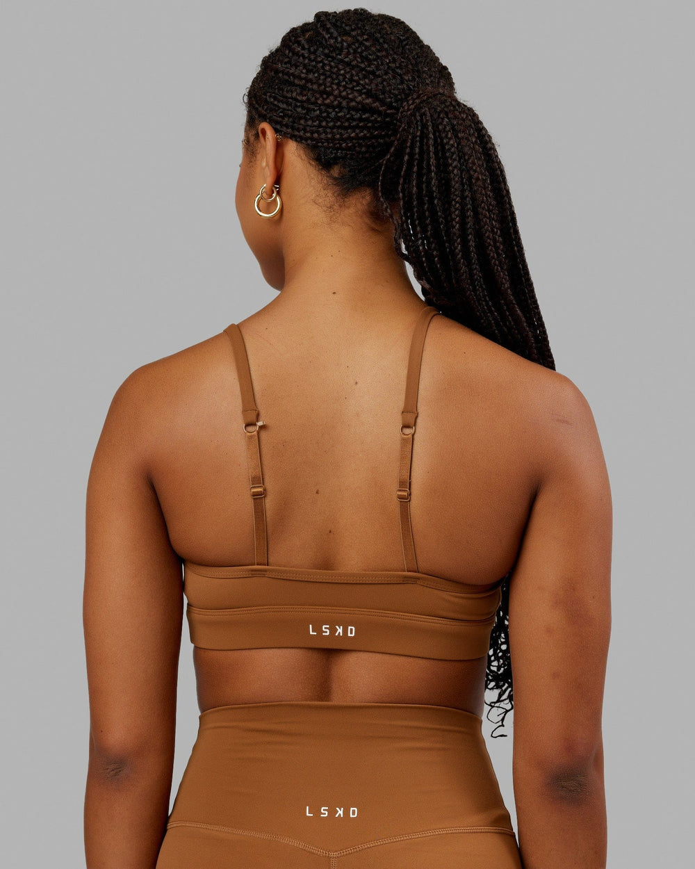 Woman wearing Elixir Sports Bra - Camel