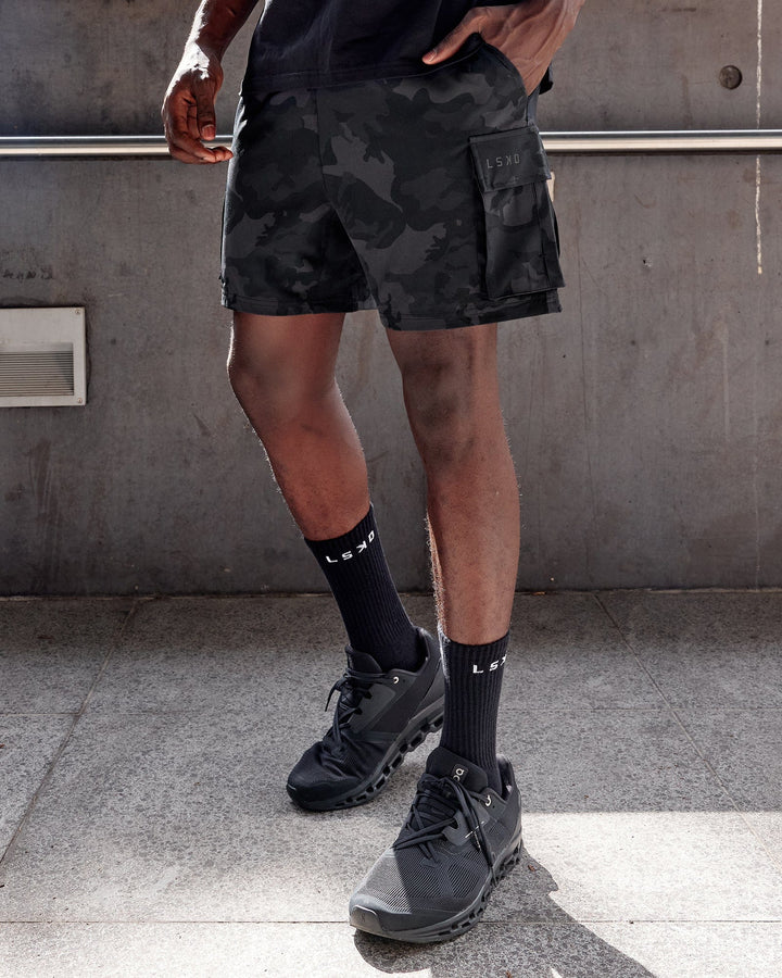 Man wearing Energy Stretch Performance Cargo Short - Black Camo
