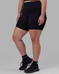 Woman wearing O.G. Fusion Ultra High-Rise 6" Short Pockets - Black | Model:Milly | Size:S