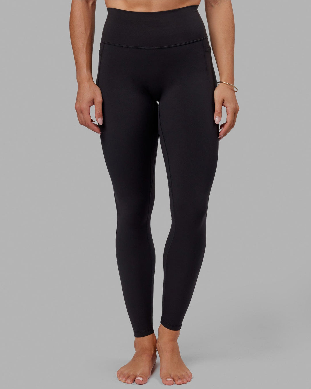 Woman wearing O.G. Fusion Ultra High-Rise Tall Legging Pockets - Black | Model:Bree | Size:S