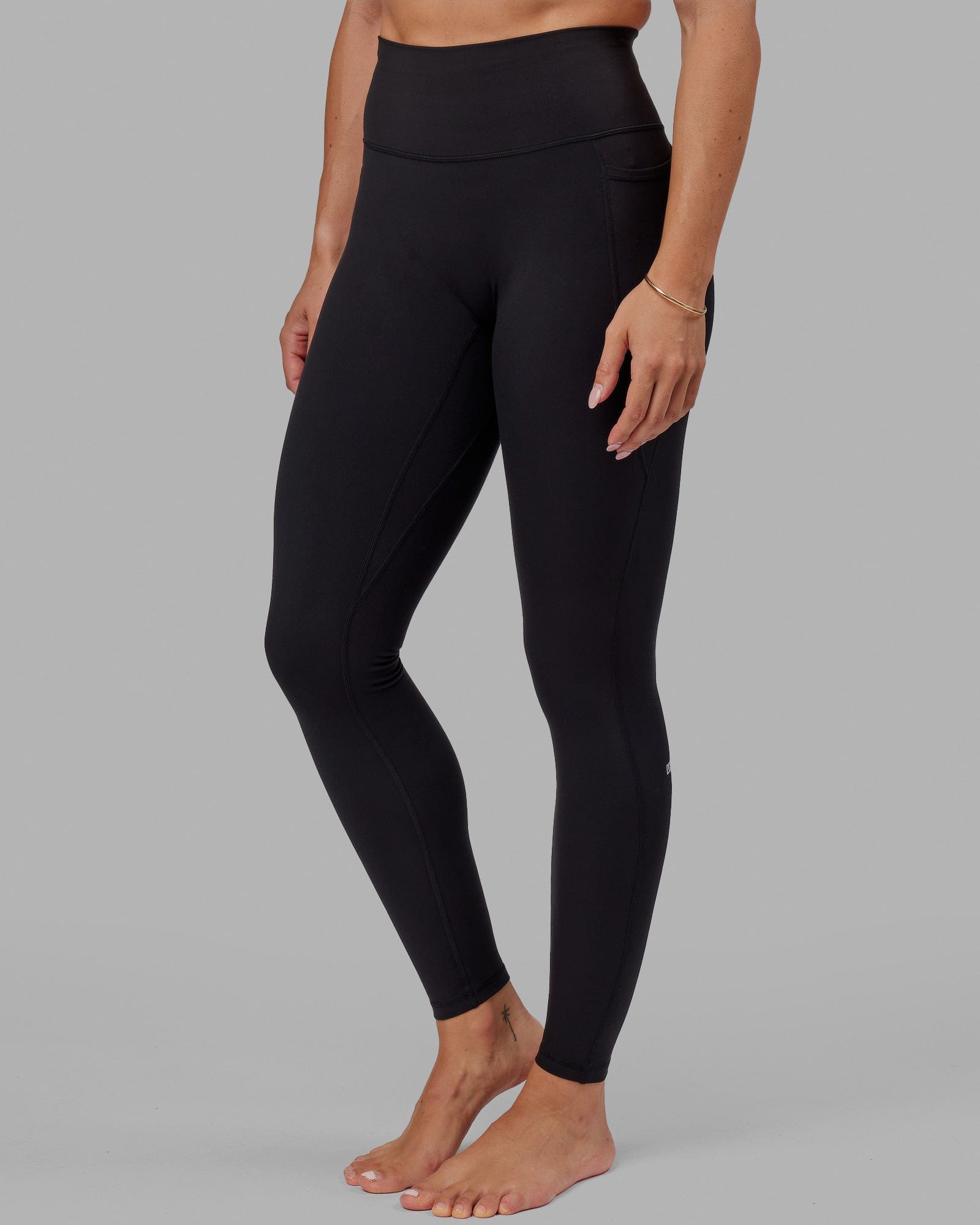 Woman wearing O.G. Fusion Ultra High-Rise Tall Legging Pockets - Black | Model:Bree | Size:S