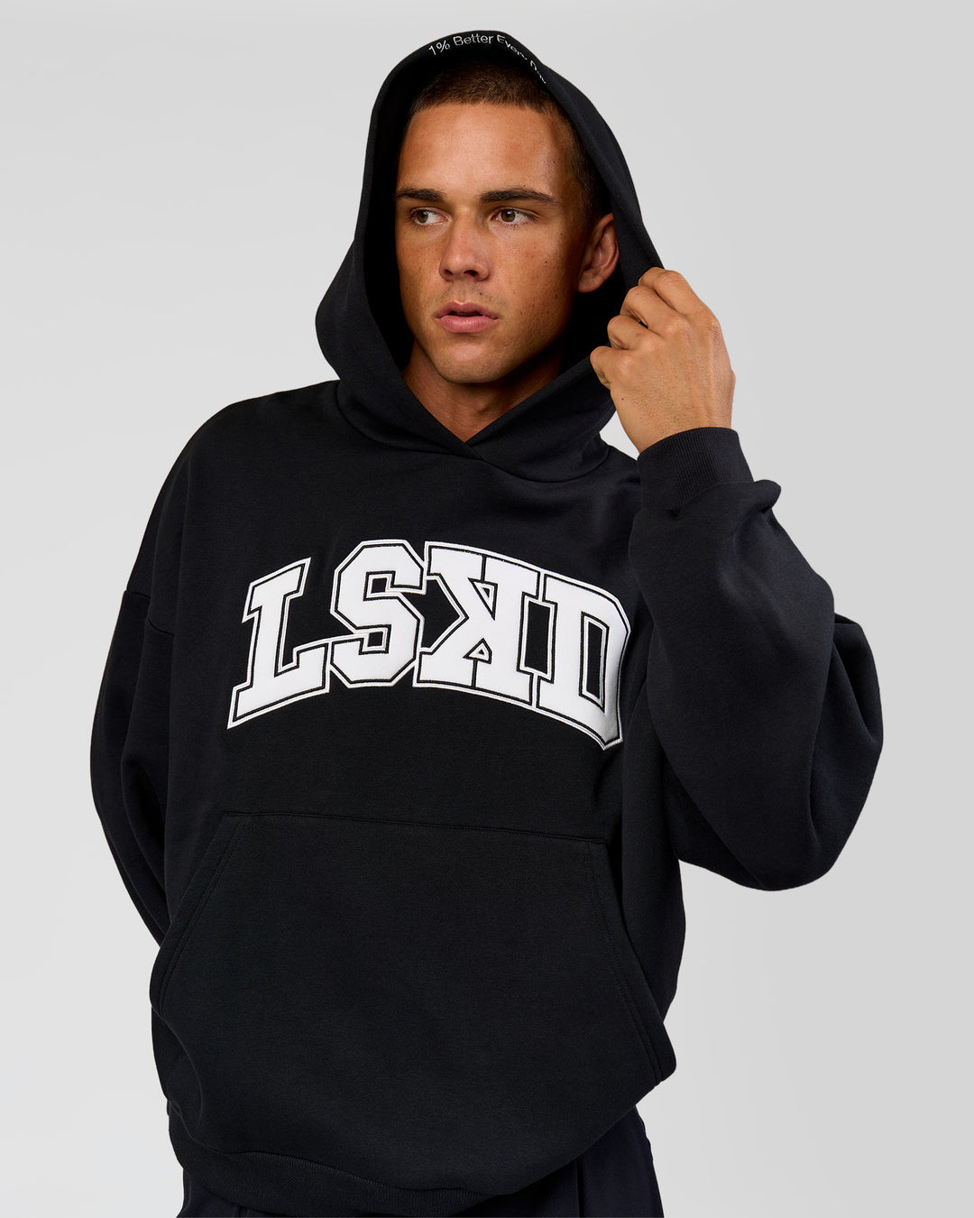 Man wearing Varsity Boxy Hoodie - Caviar-White | Model:Albert | Size:L