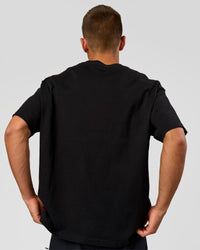 Man wearing Varsity EST Heavyweight Oversized Tee  - Black-Off White | Model:Albert | Size:L