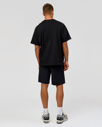 Man wearing Varsity EST Heavyweight Oversized Tee  - Black-Off White | Model:Albert | Size:L