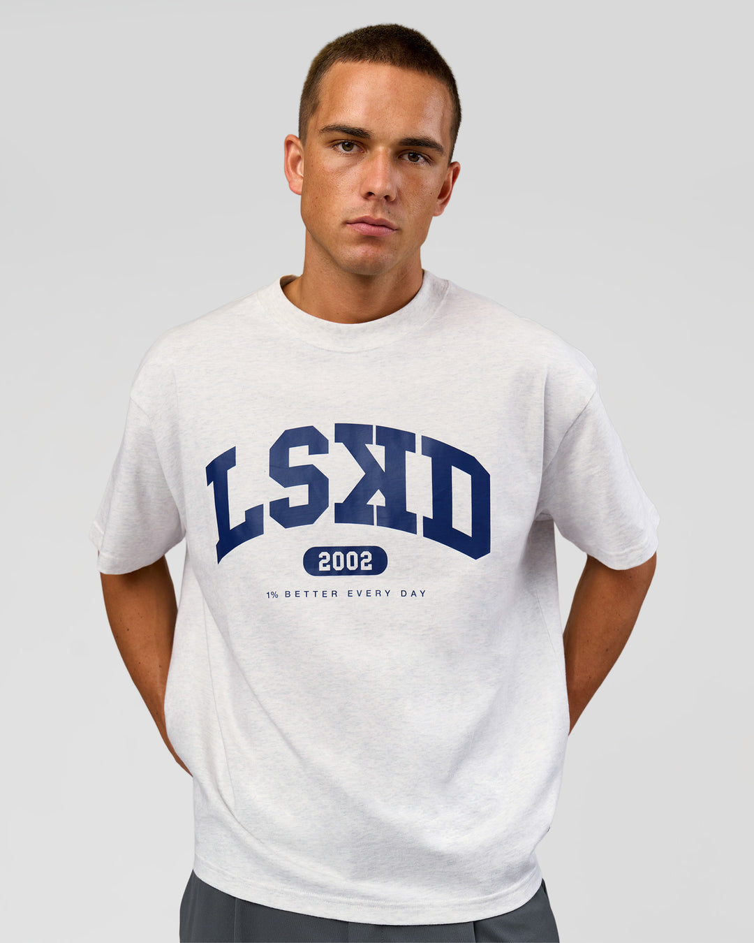 Man wearing Varsity EST Heavyweight Oversized Tee  - Silver Marl-Future Navy | Model:Albert | Size:L