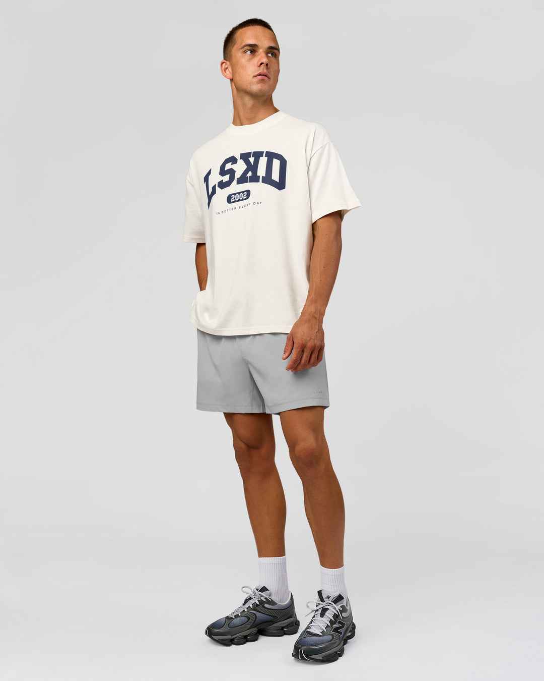 Man wearing Varsity EST Heavyweight Oversized Tee  - Off White-Future Navy | Model:Albert | Size:L