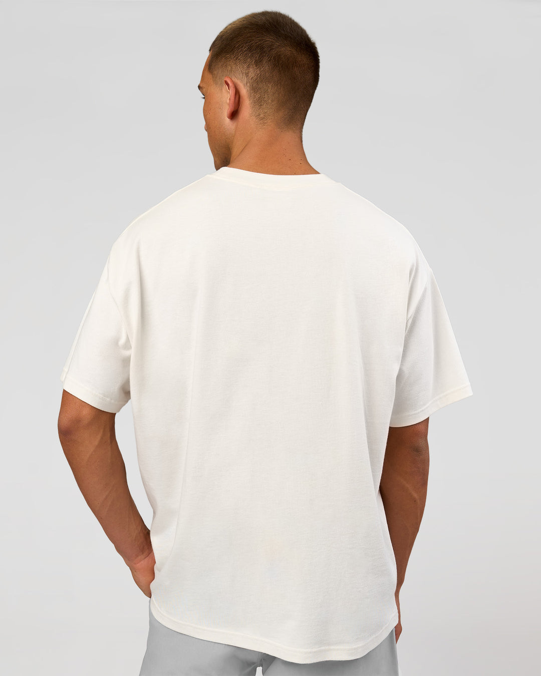 Man wearing Varsity EST Heavyweight Oversized Tee  - Off White-Future Navy | Model:Albert | Size:L