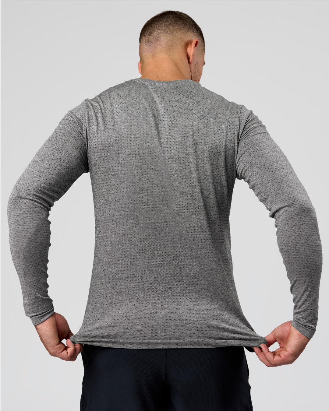 Man wearing AeroFLX+ Seamless Long Sleeve Tee (Set in Sleeve) - Dark Storm/Alloy | Model:Jaiden | Size:L - view 8