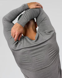 Man wearing AeroFLX+ Seamless Long Sleeve Tee (Set in Sleeve) - Dark Storm/Alloy | Model:Jaiden | Size:L | Thumbnail Index: 8