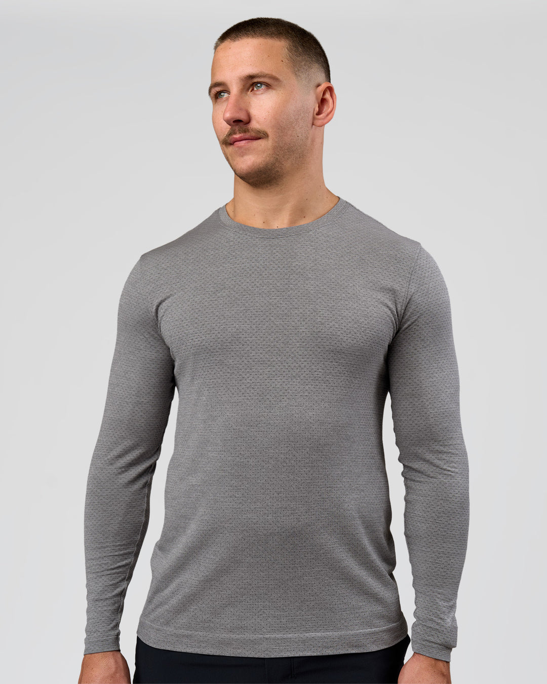 Man wearing AeroFLX+ Seamless Long Sleeve Tee (Set in Sleeve) - Dark Storm/Alloy | Model:Jaiden | Size:L - view 13