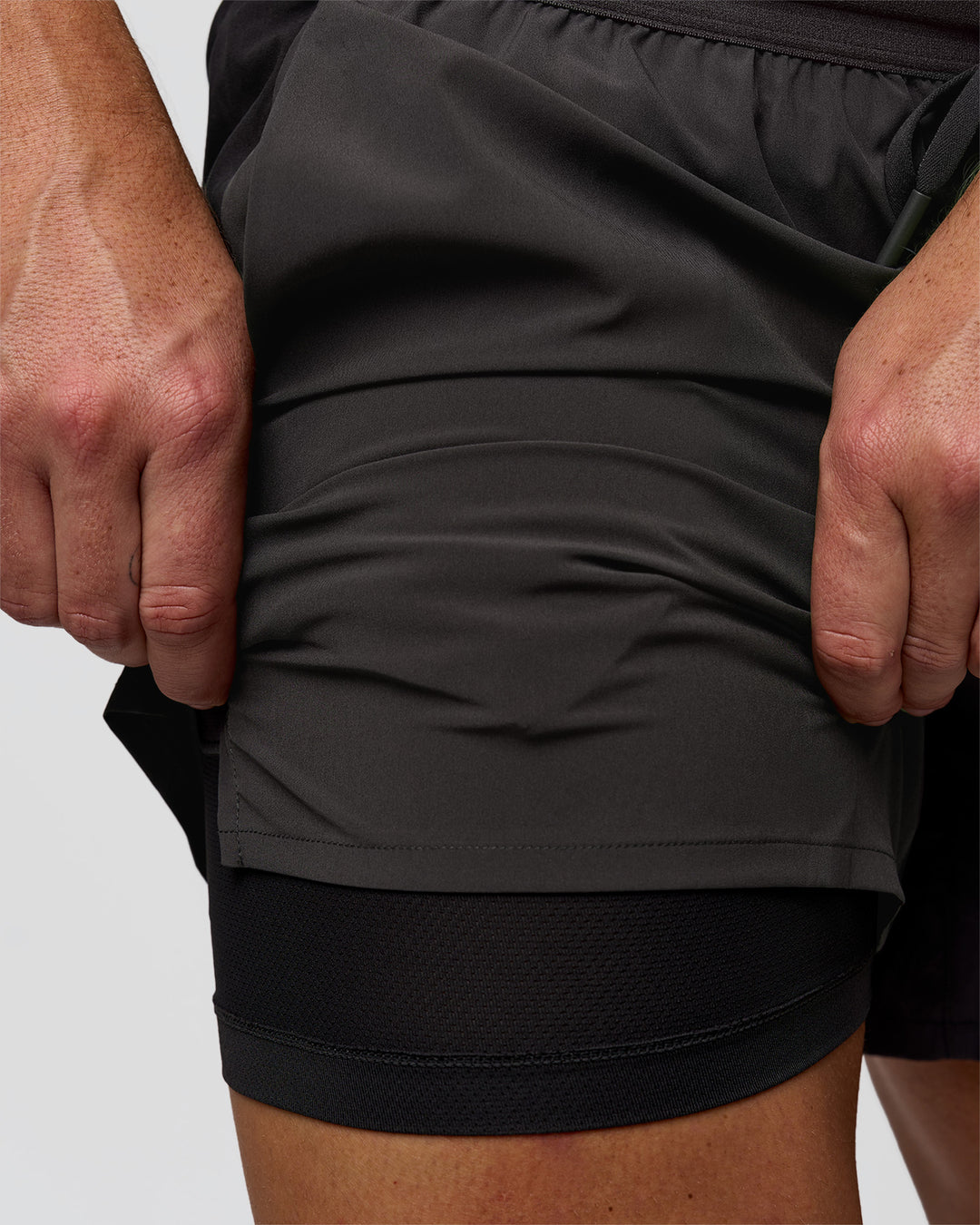 Man wearing Pace 5" Lined Running Short - Black-Onyx | Model:Jaiden | Size:L