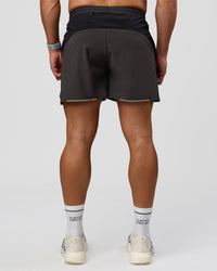 Man wearing Pace 5" Lined Running Short - Black-Onyx | Model:Jaiden | Size:L