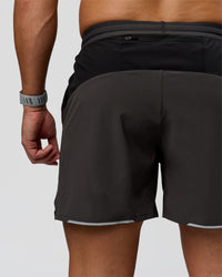 Man wearing Pace 5" Lined Running Short - Black-Onyx | Model:Jaiden | Size:L