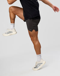 Man wearing Pace 5" Lined Running Short - Black-Onyx | Model:Jaiden | Size:L