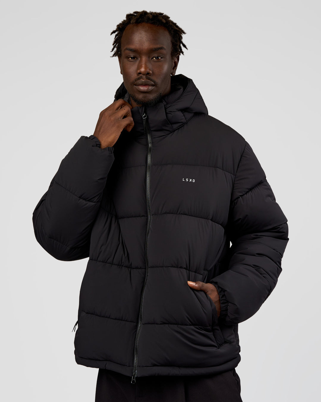 Man wearing Base Puffer Jacket - Black | Model:Okello | Size:L - view 1