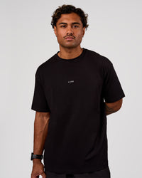 Man wearing Base FLXCotton Tee Oversized - Black | Model:Xav | Size:L | Thumbnail Index: 0