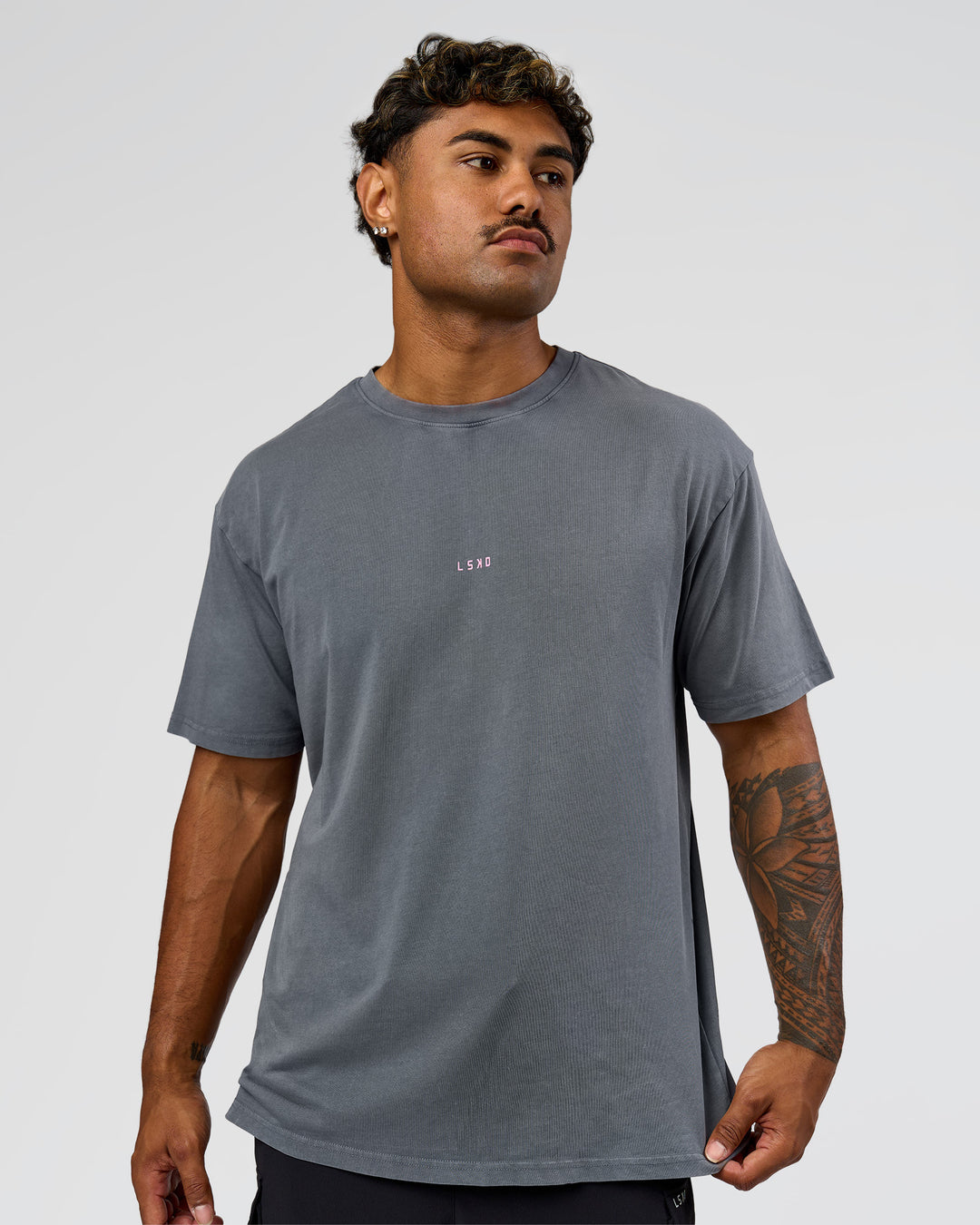 Man wearing Built On Values FLXCotton Oversized Tee - Dark Storm Washed-Pink Rose | Model:Xav | Size:L - view 9