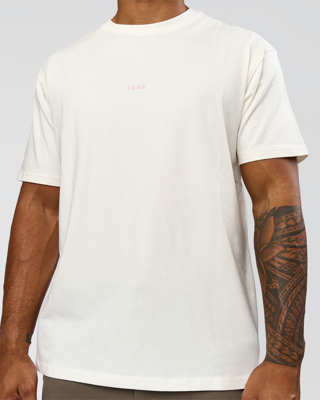 Man wearing Built On Values FLXCotton Oversized Tee - Off White-Pink Rose | Model:Xav | Size:L - view 12