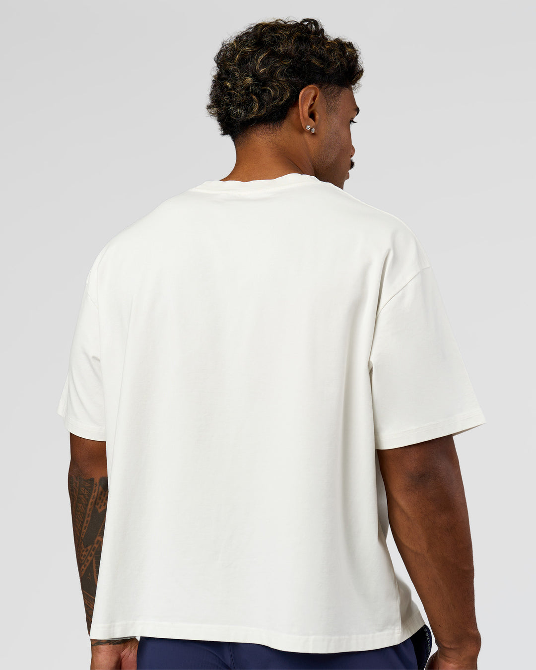 Man wearing Greatest of All Time Heavyweight FLXCotton Boxed Tee - Off White Washed | Model:Xav | Size:L - view 10