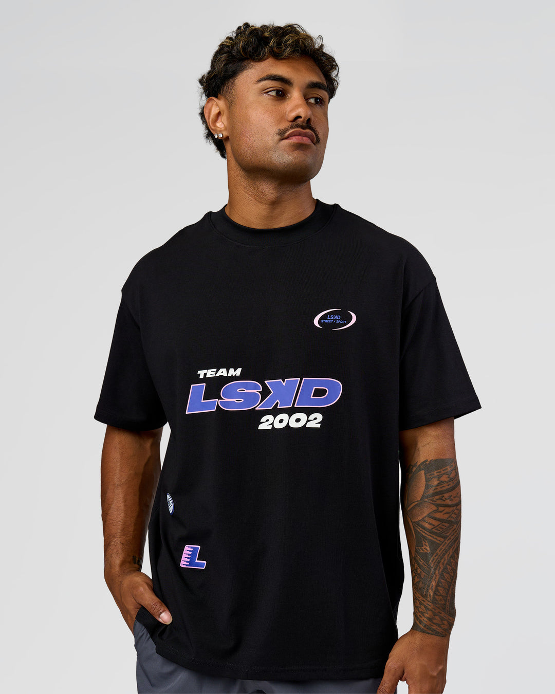 Man wearing League Heavyweight FLXCotton Oversized Tee - Black-Power Cobalt | Model:Xav | Size:L