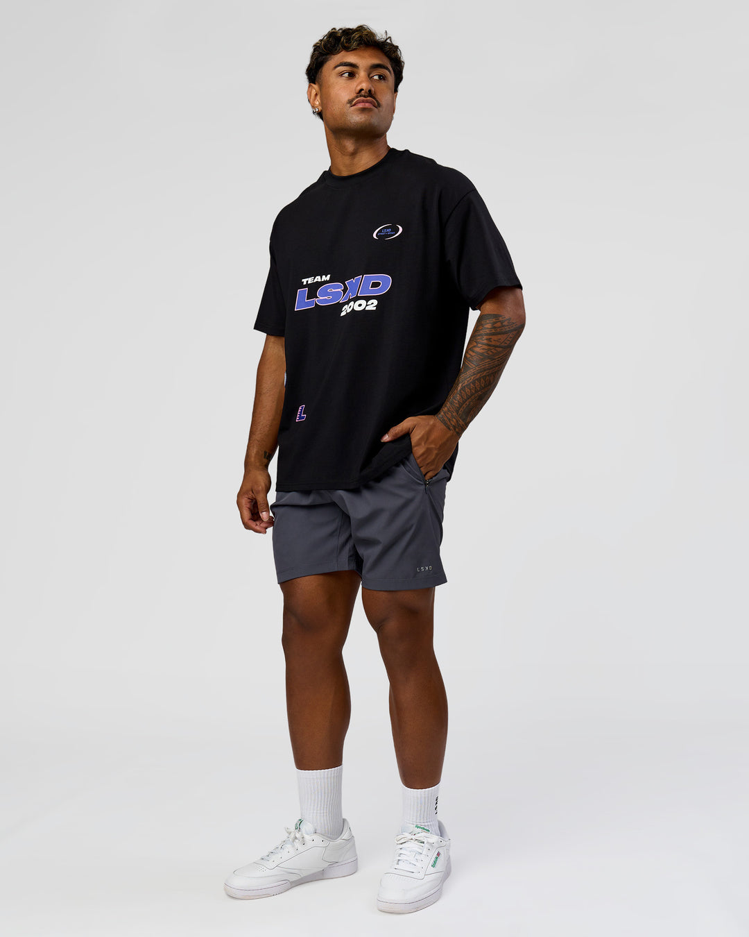 Man wearing League Heavyweight FLXCotton Oversized Tee - Black-Power Cobalt | Model:Xav | Size:L