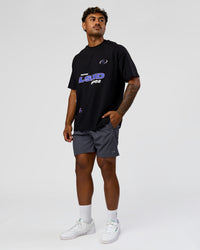 Man wearing League Heavyweight FLXCotton Oversized Tee - Black-Power Cobalt | Model:Xav | Size:L
