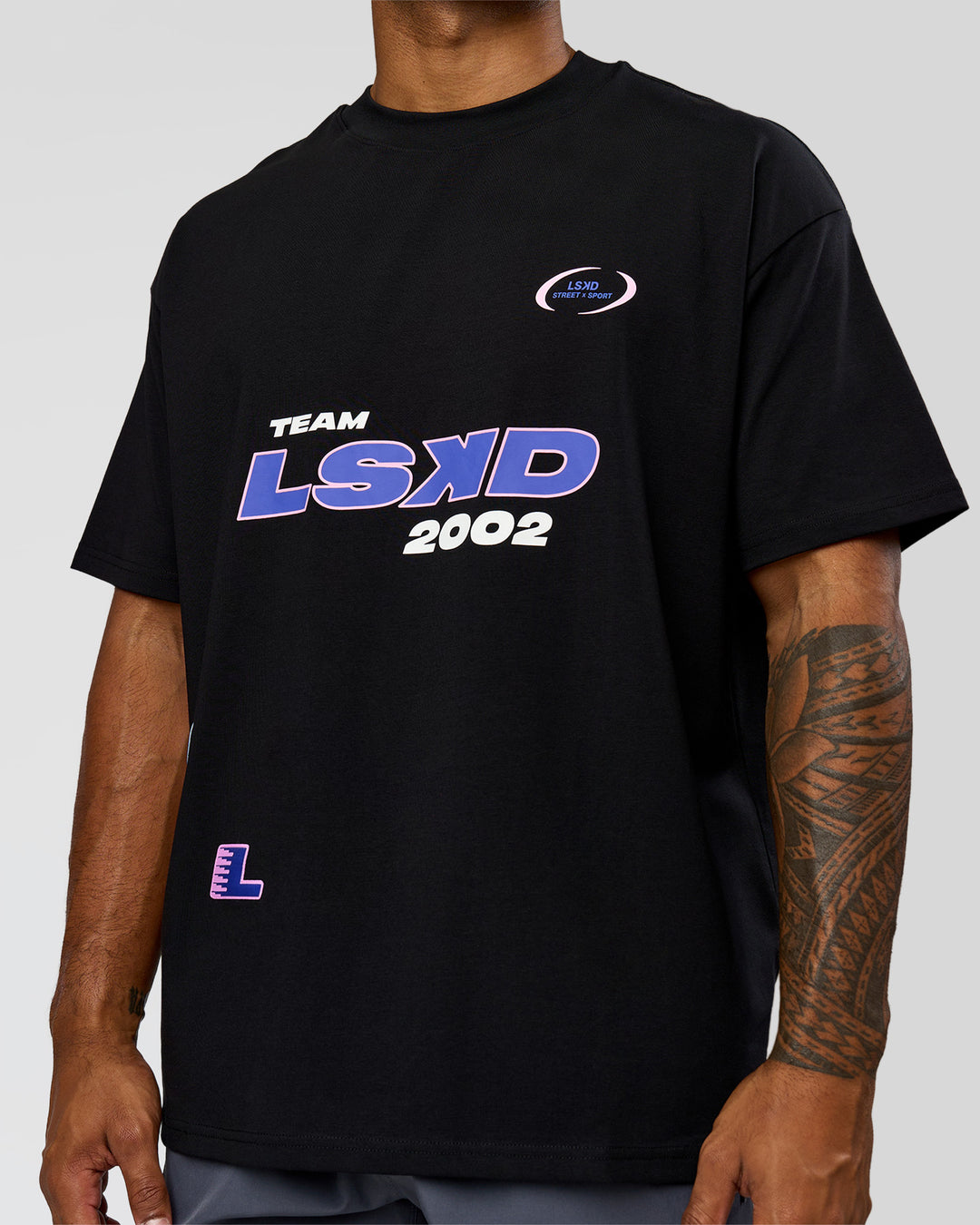 Man wearing League Heavyweight FLXCotton Oversized Tee - Black-Power Cobalt | Model:Xav | Size:L