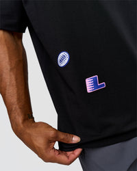 Man wearing League Heavyweight FLXCotton Oversized Tee - Black-Power Cobalt | Model:Xav | Size:L