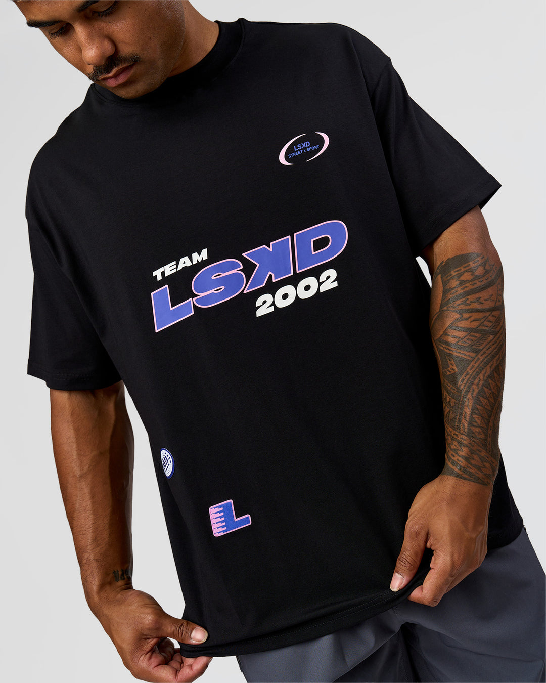 Man wearing League Heavyweight FLXCotton Oversized Tee - Black-Power Cobalt | Model:Xav | Size:L