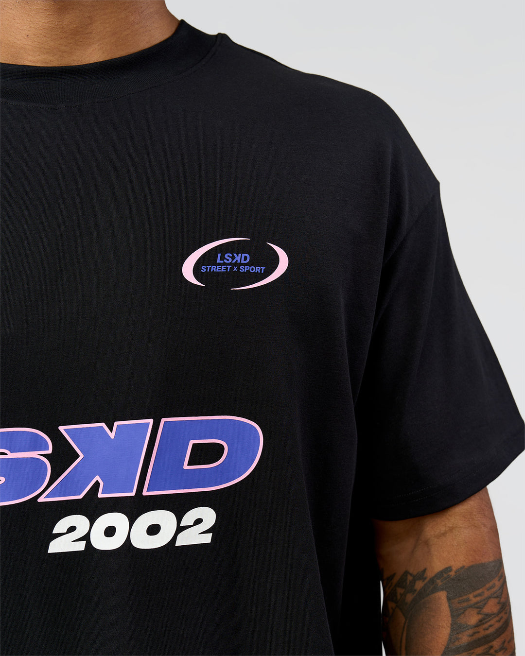 Man wearing League Heavyweight FLXCotton Oversized Tee - Black-Power Cobalt | Model:Xav | Size:L