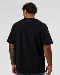 Man wearing League Heavyweight FLXCotton Oversized Tee - Black-Power Cobalt | Model:Xav | Size:L