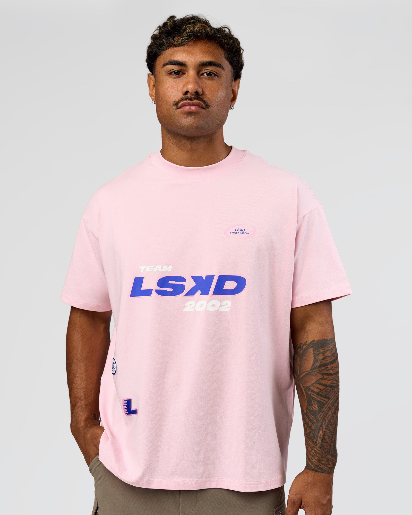 Man wearing League Heavyweight FLXCotton Oversized Tee - Marshmallow-Power Cobalt | Model:Xav | Size:L