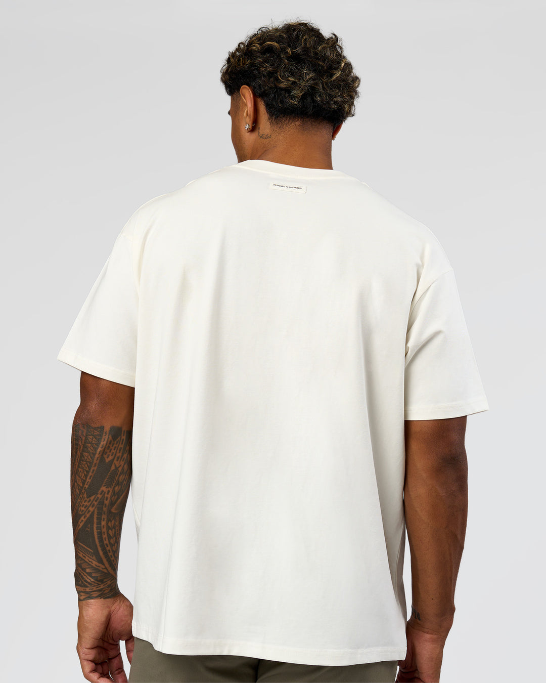 Man wearing League Heavyweight FLXCotton Oversized Tee - Off White-Ground Coffee | Model:Xav | Size:L