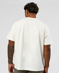 Man wearing League Heavyweight FLXCotton Oversized Tee - Off White-Ground Coffee | Model:Xav | Size:L