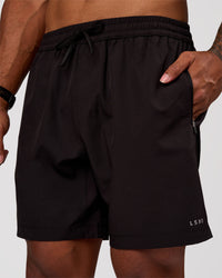 Man wearing Rep 7" Performance Short - Black-White | Model:Xav | Size:L | Thumbnail Index: 0