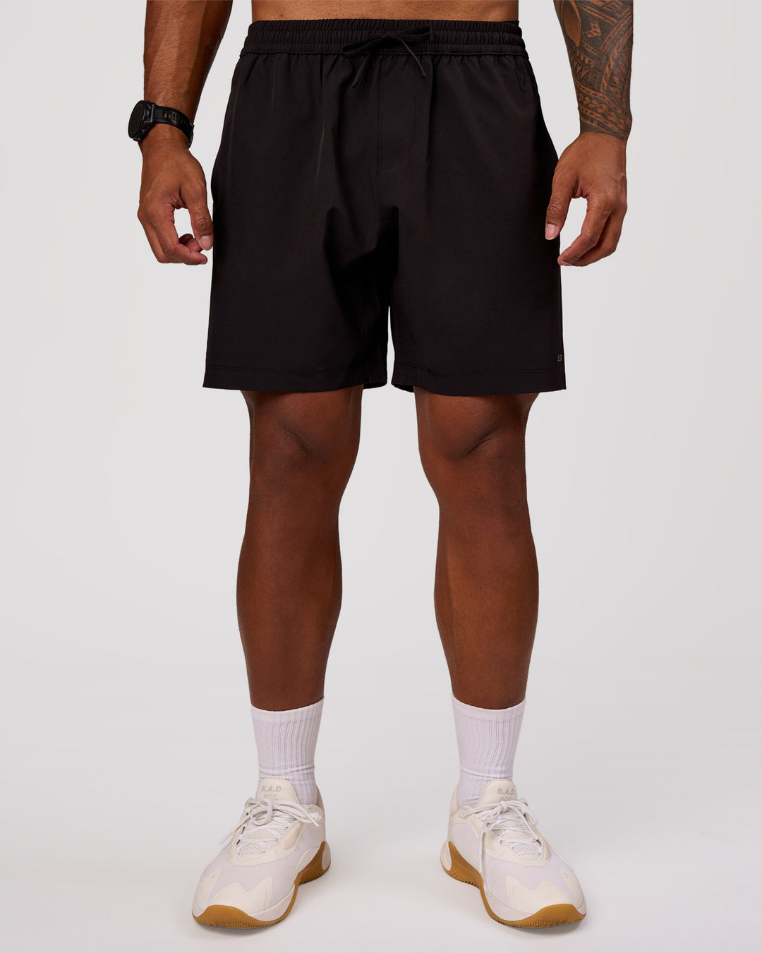 Man wearing Rep 7" Performance Short - Black-White | Model:Xav | Size:L - view 2