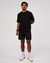 Man wearing Rep 7" Performance Short - Black-White | Model:Xav | Size:L | Thumbnail Index: 2