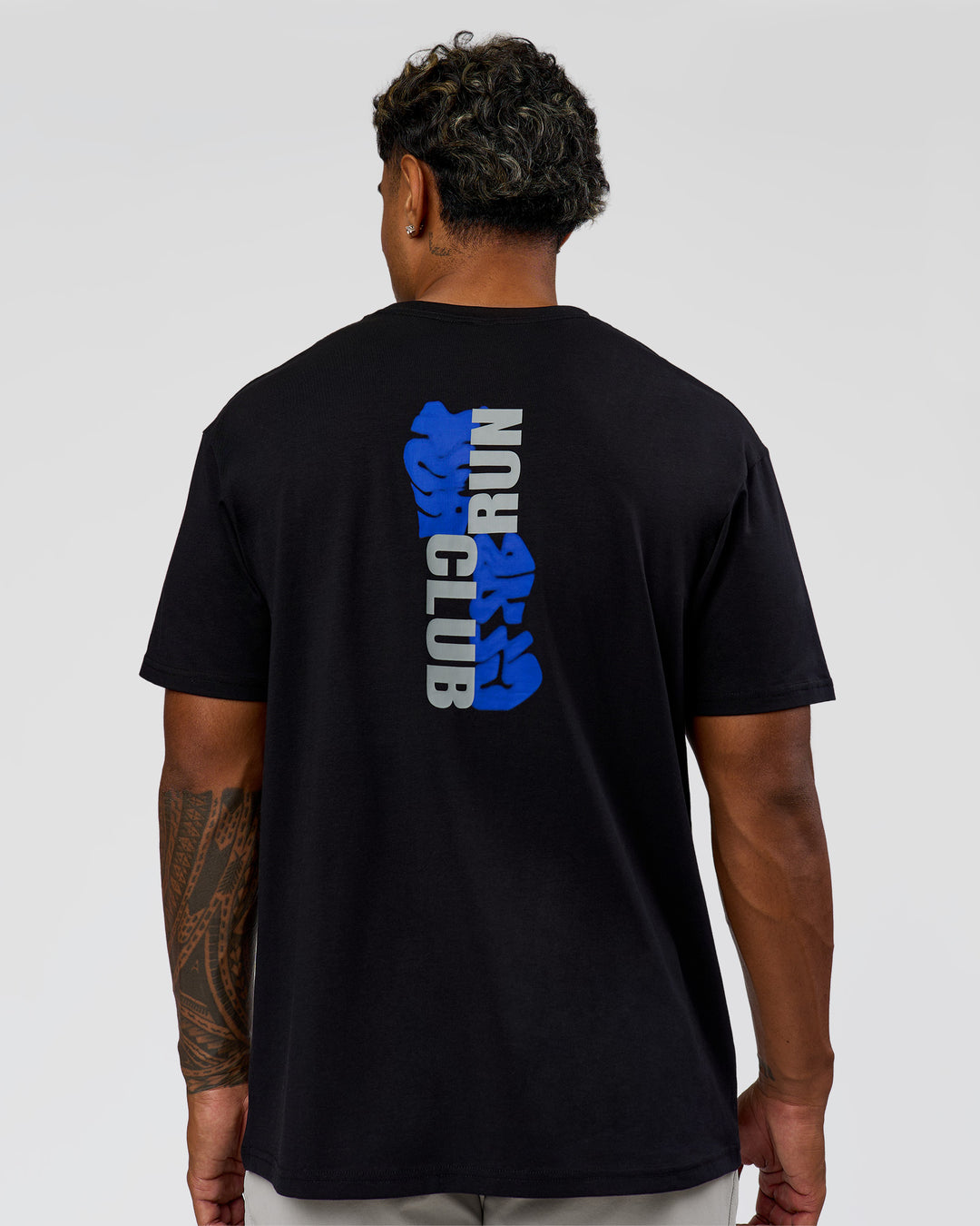 Man wearing Run Club Elevate FLXCotton Oversized Tee - Black-Electric Indigo | Model:Xav | Size:L