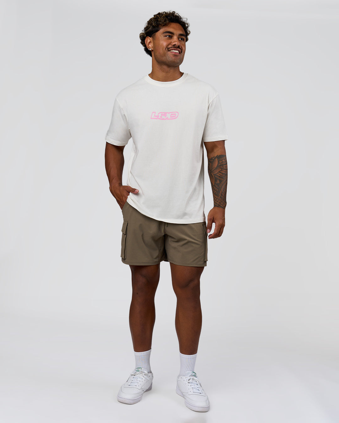 Man wearing SoCal 26 FLXCotton Oversize Tee  - Off White-Pink Rose | Model:Xav | Size:L - view 10