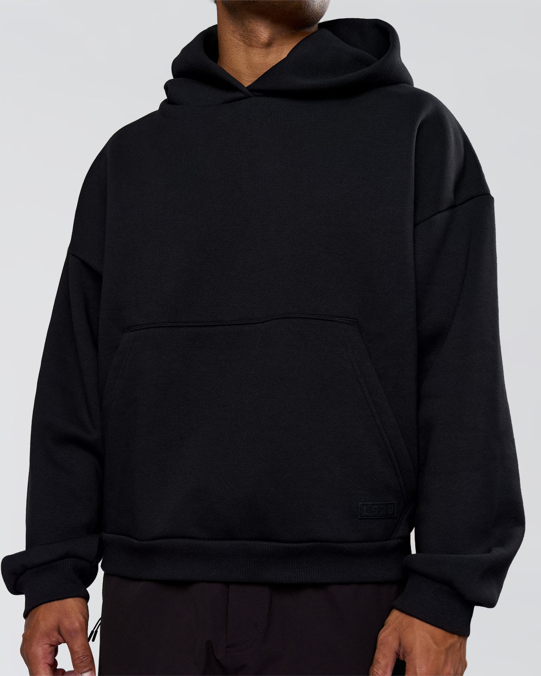 Man wearing Tonal Legacy Boxy Hoodie - Black-Black | Model:Xav | Size:L - view 12