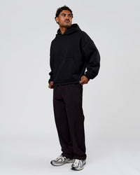 Man wearing Tonal Legacy Boxy Hoodie - Black-Black | Model:Xav | Size:L | Thumbnail Index: 17