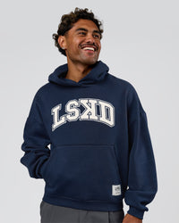 Man wearing Varsity Boxy Hoodie - Future Navy-White | Model:Xav | Size:L | Thumbnail Index: 1